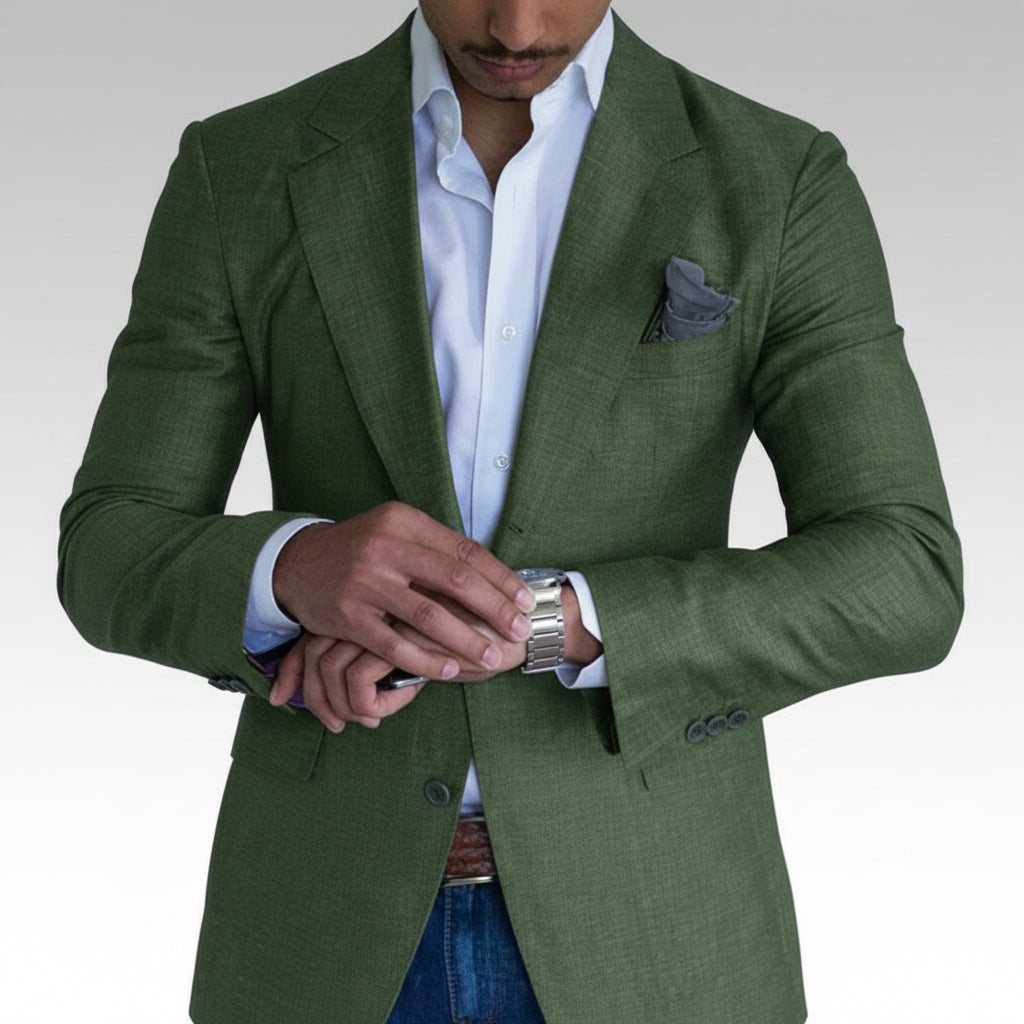 Man wearing olive green blazer, white dress shirt, and silver watch adjusting cuff