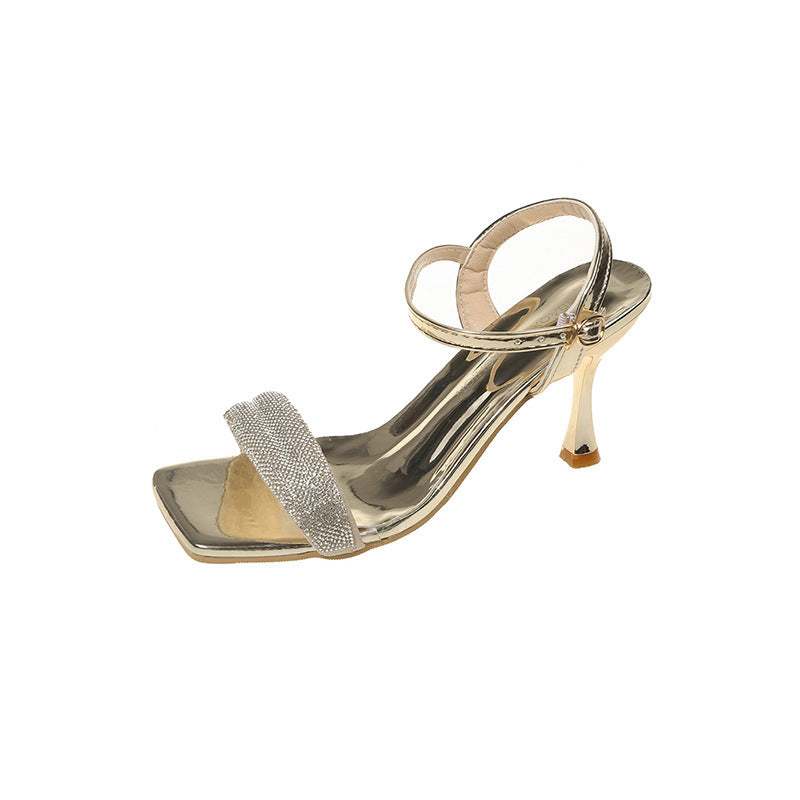 gold high heel sandal with rhinestone front strap and ankle strap on white background
