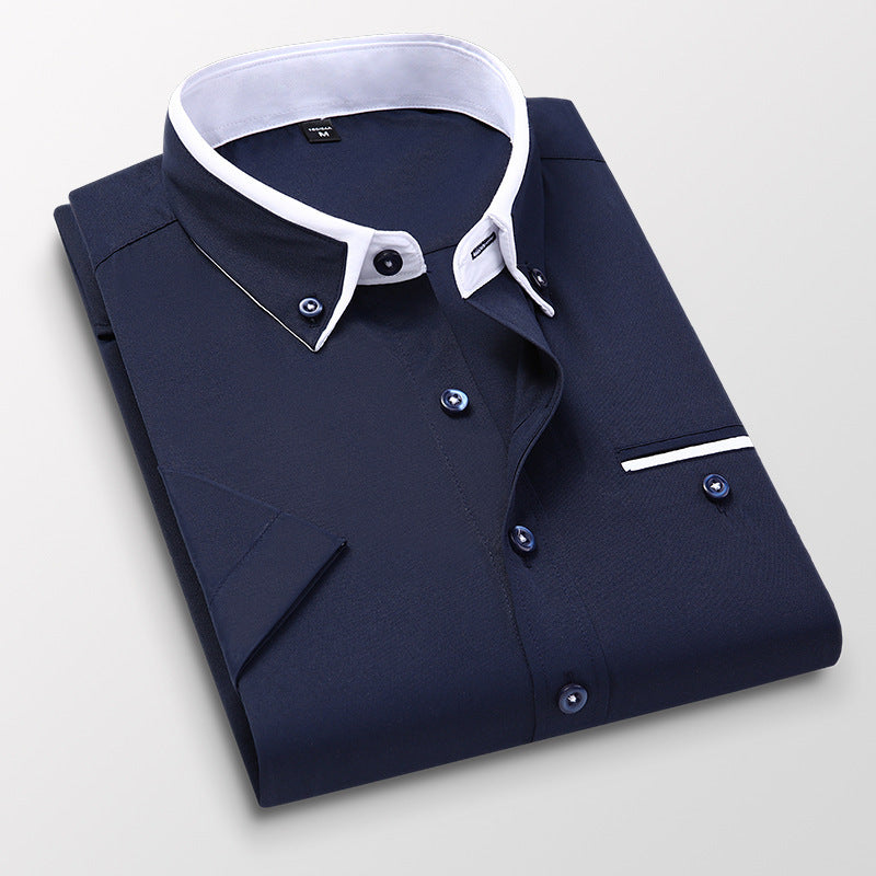 Folded navy blue men's dress shirt with contrasting white collar and button details on light background