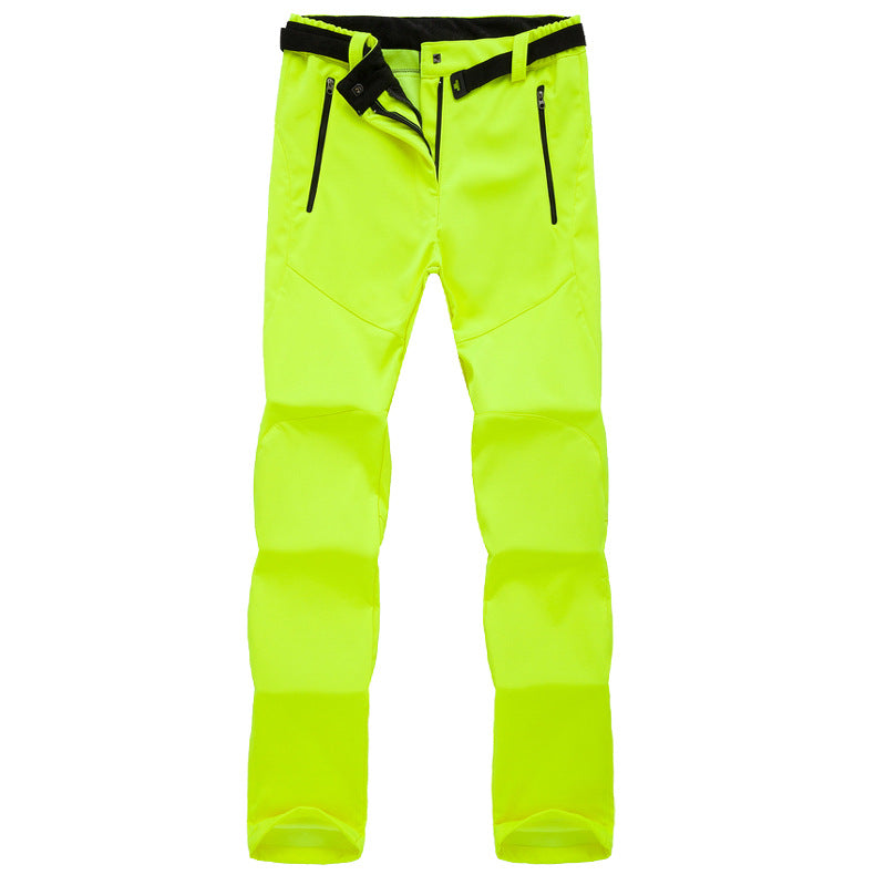 High-visibility neon yellow outdoor pants with black zipper pockets and adjustable waist belt