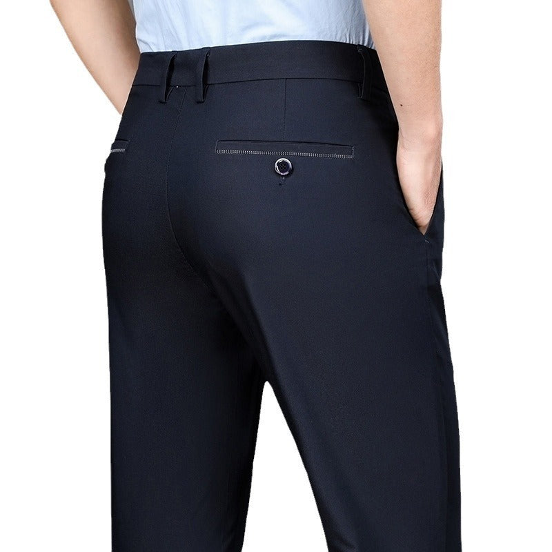 Back view of man wearing slim fit navy blue dress pants with button pocket and light blue shirt