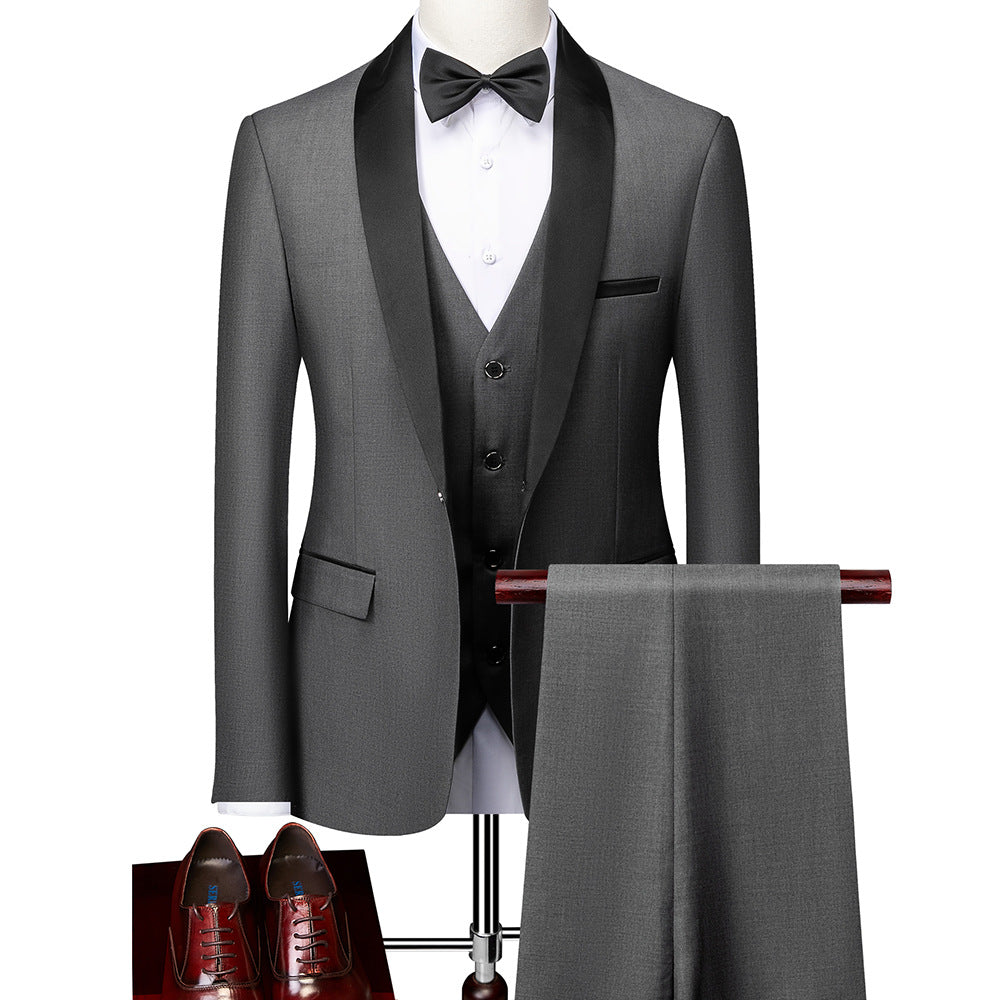 Gray three-piece tuxedo with black satin lapels, white shirt, black bow tie, matching pants, and brown dress shoes