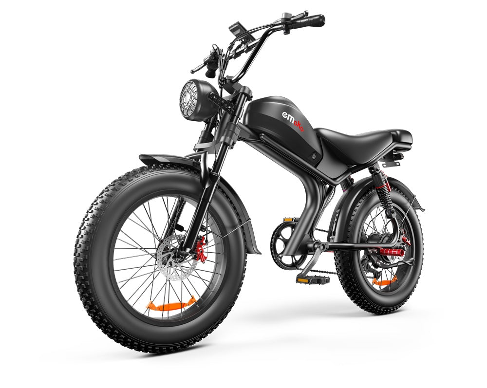 Black Emoka electric bike with fat tires, front headlight, and cushioned seat on white background