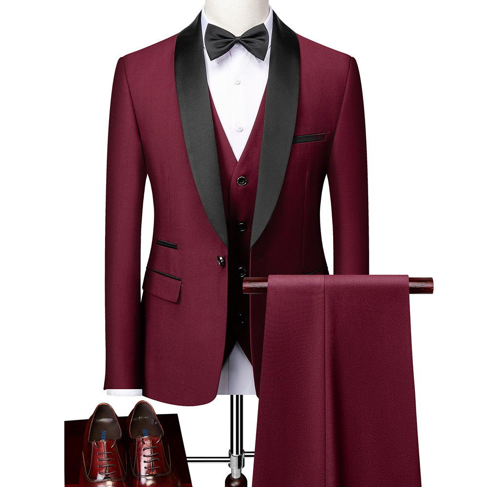 Men's burgundy tuxedo suit with black satin lapels, white shirt, black bow tie, matching pants, and brown dress shoes
