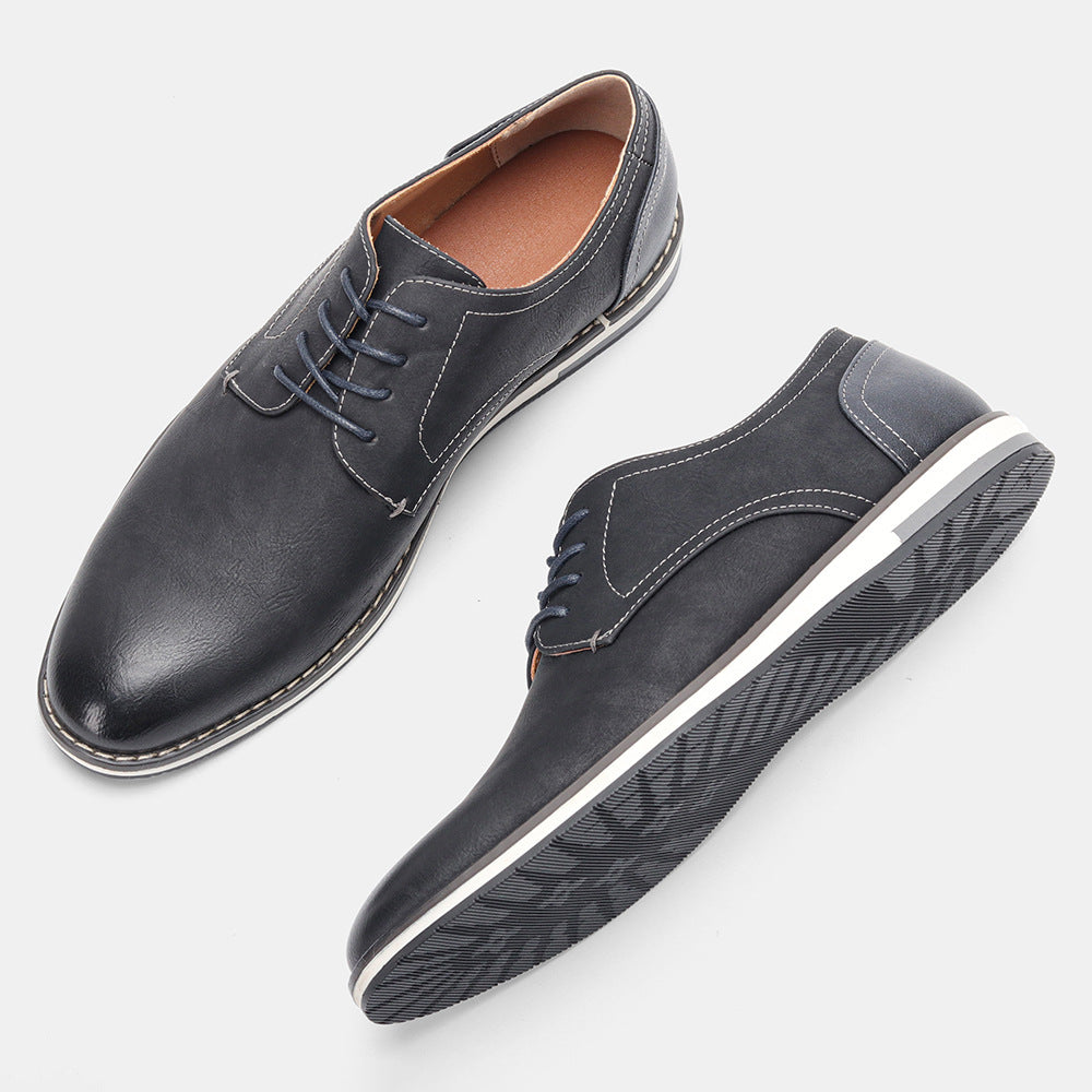 Pair of stylish black men's casual lace-up shoes with white sole and textured outsole