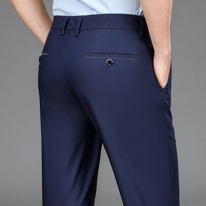 Man wearing navy blue formal trousers with back button pockets and hands in side pockets