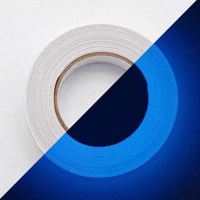 Roll of white adhesive tape on a surface split between white and blue backgrounds