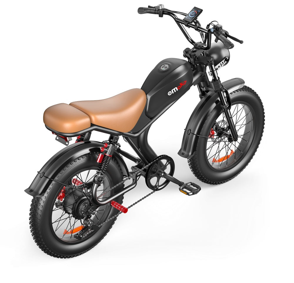 Black and brown Emoka electric bike with fat tires, digital display, and suspension on white background
