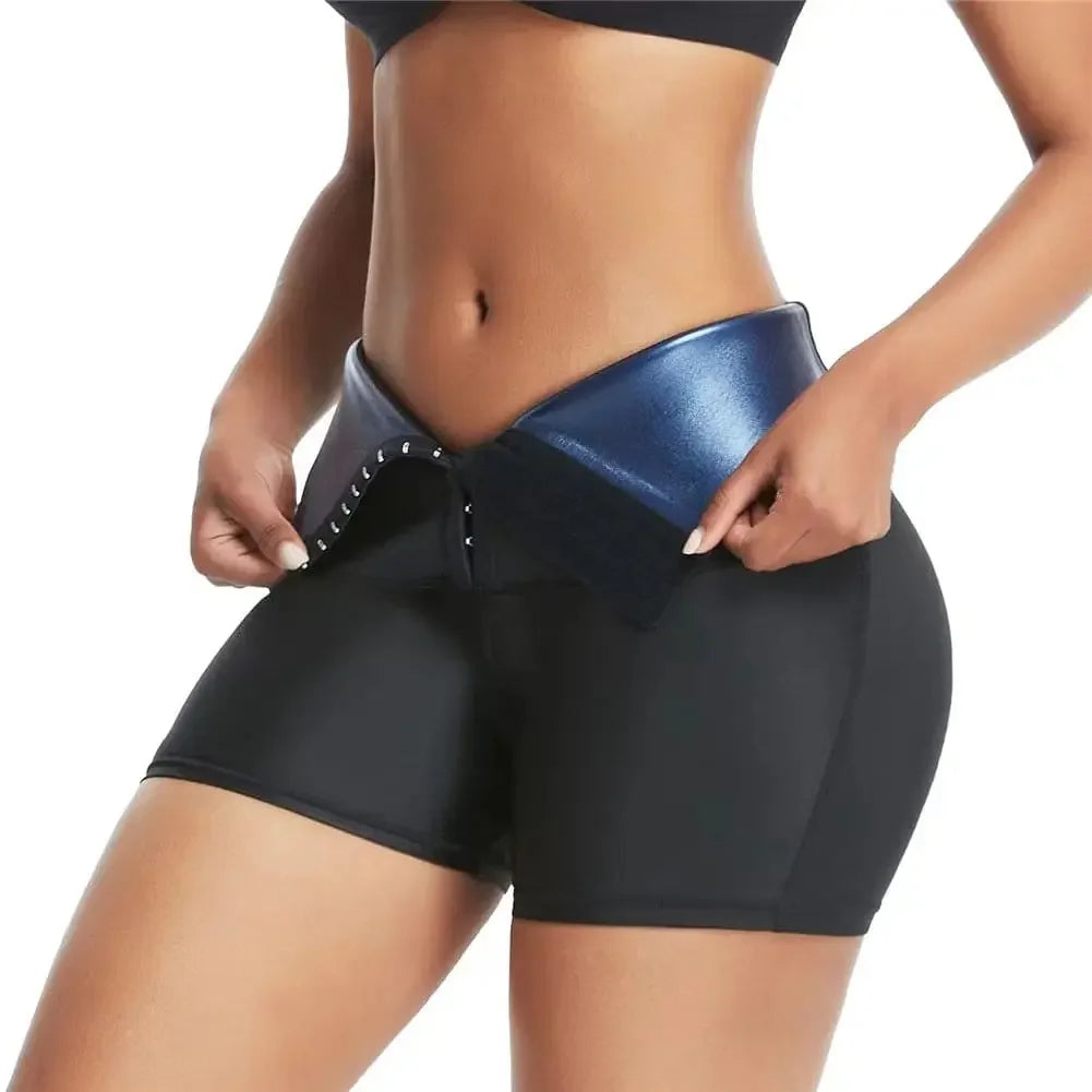Woman wearing high-waisted black and blue waist trainer shorts with hook closure, fitness apparel