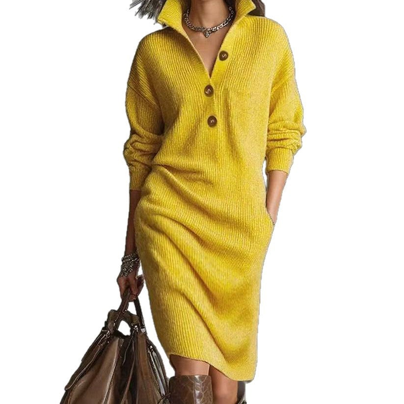 Woman wearing a yellow knit sweater dress with buttons, carrying a brown bag and accessorized with bracelets and necklace