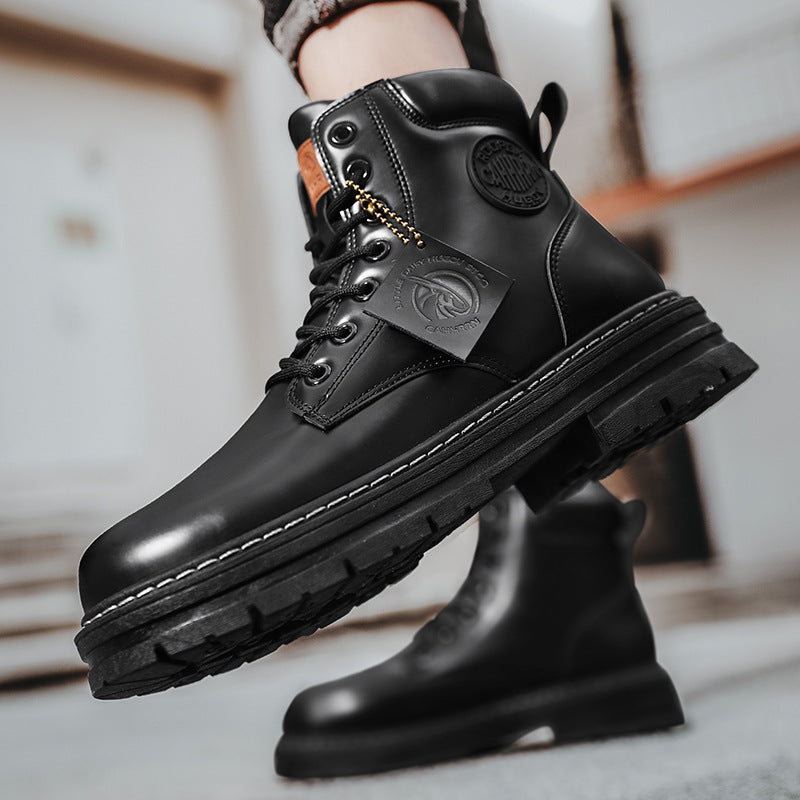 Close-up of black leather combat boots with branded tag and rugged sole worn indoors