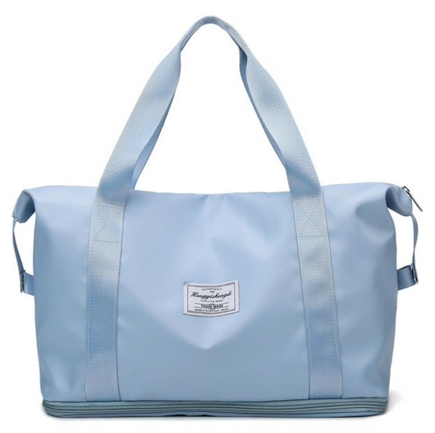 Light blue waterproof travel duffel bag with sturdy handles and front label