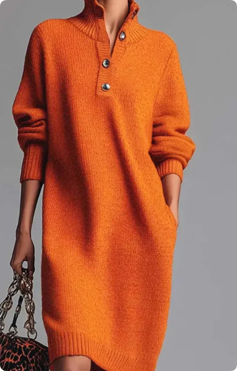 Woman wearing cozy orange knit sweater dress with buttoned collar and long sleeves, holding leopard print bag