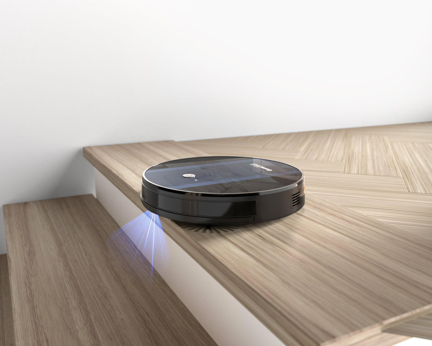 Black robotic vacuum cleaner near edge of wooden staircase with blue sensor light