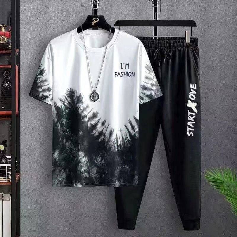 Men's black and white tie-dye fashion t-shirt with necklace and black jogger pants with Start Love text