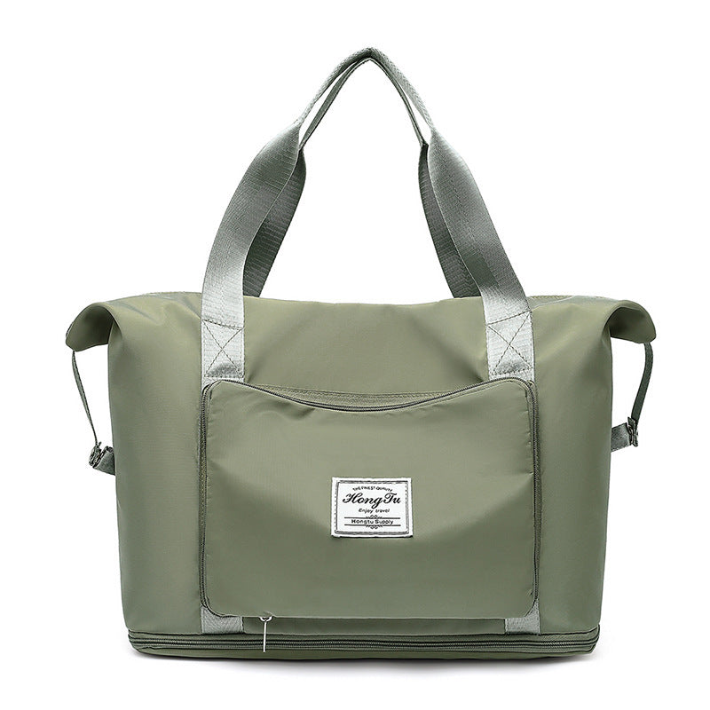 green nylon tote bag with silver handles and front zip pocket with brand label