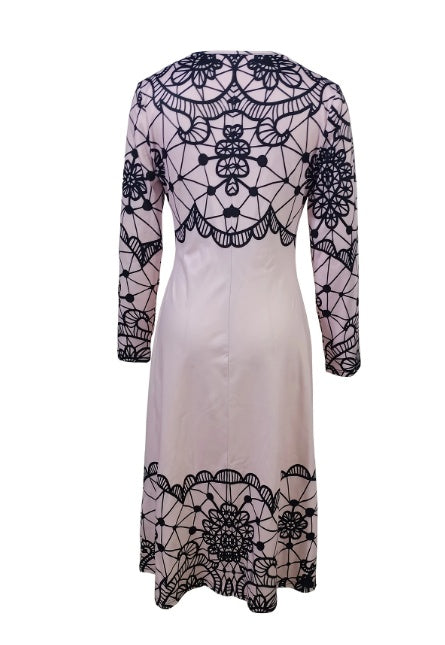 Back view of a long-sleeve beige dress with black intricate lace floral and geometric patterns