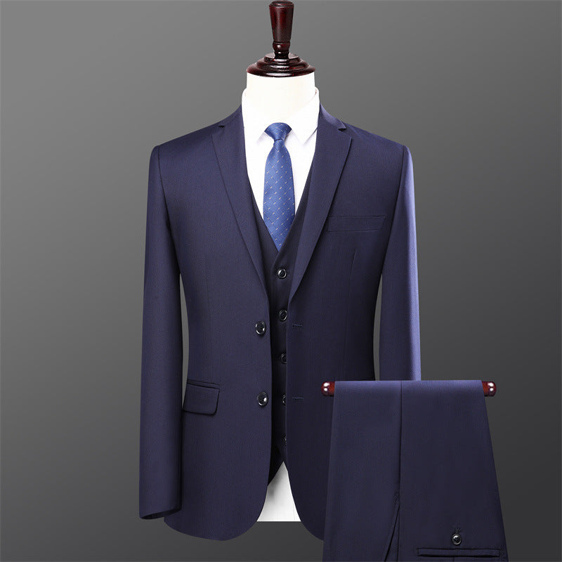 Men's navy blue three-piece suit with matching vest, blue patterned tie on mannequin