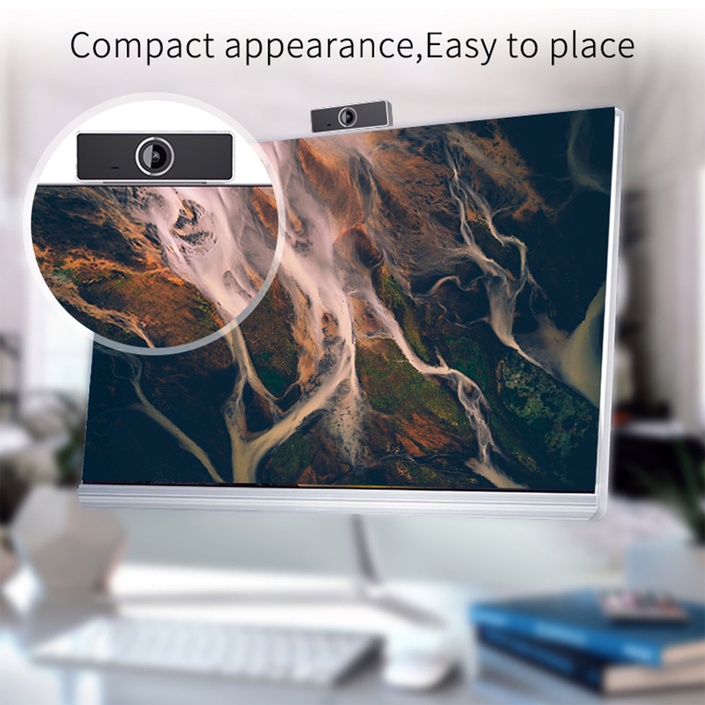 Compact black webcam mounted on top of a modern desktop computer monitor with abstract nature wallpaper