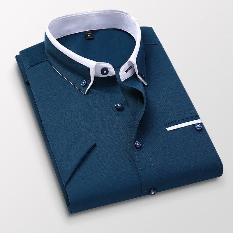 Folded navy blue dress shirt with white contrasting collar and cuffs, button-down style