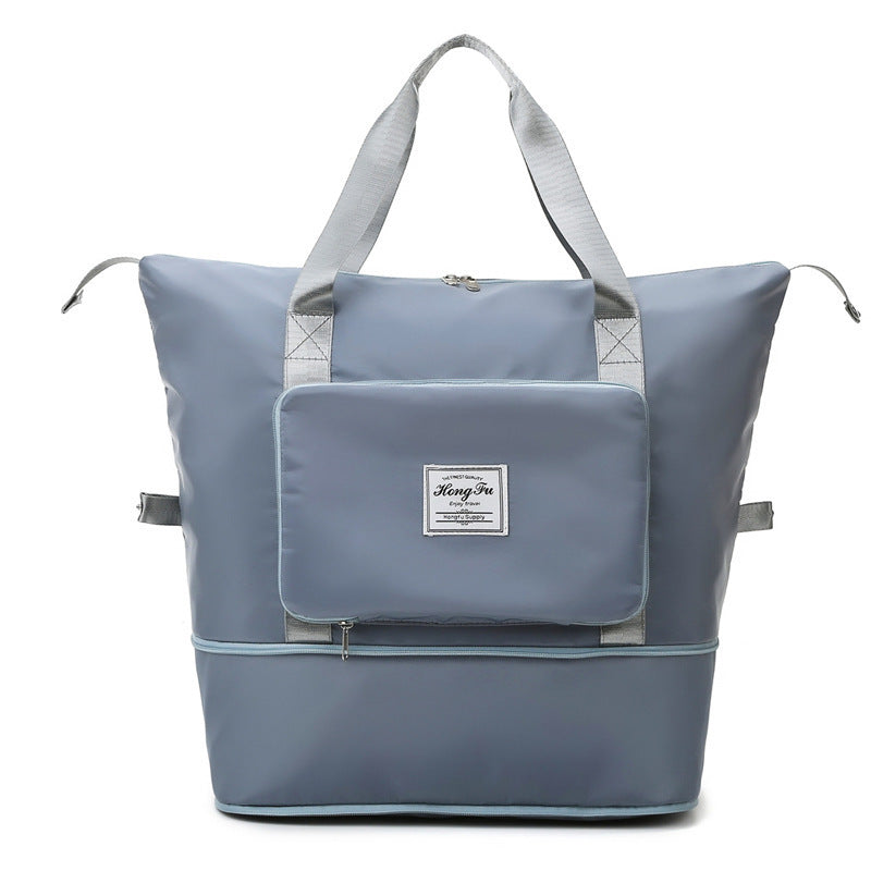 Light blue multifunctional travel tote bag with front pocket, zipper, and grey handles