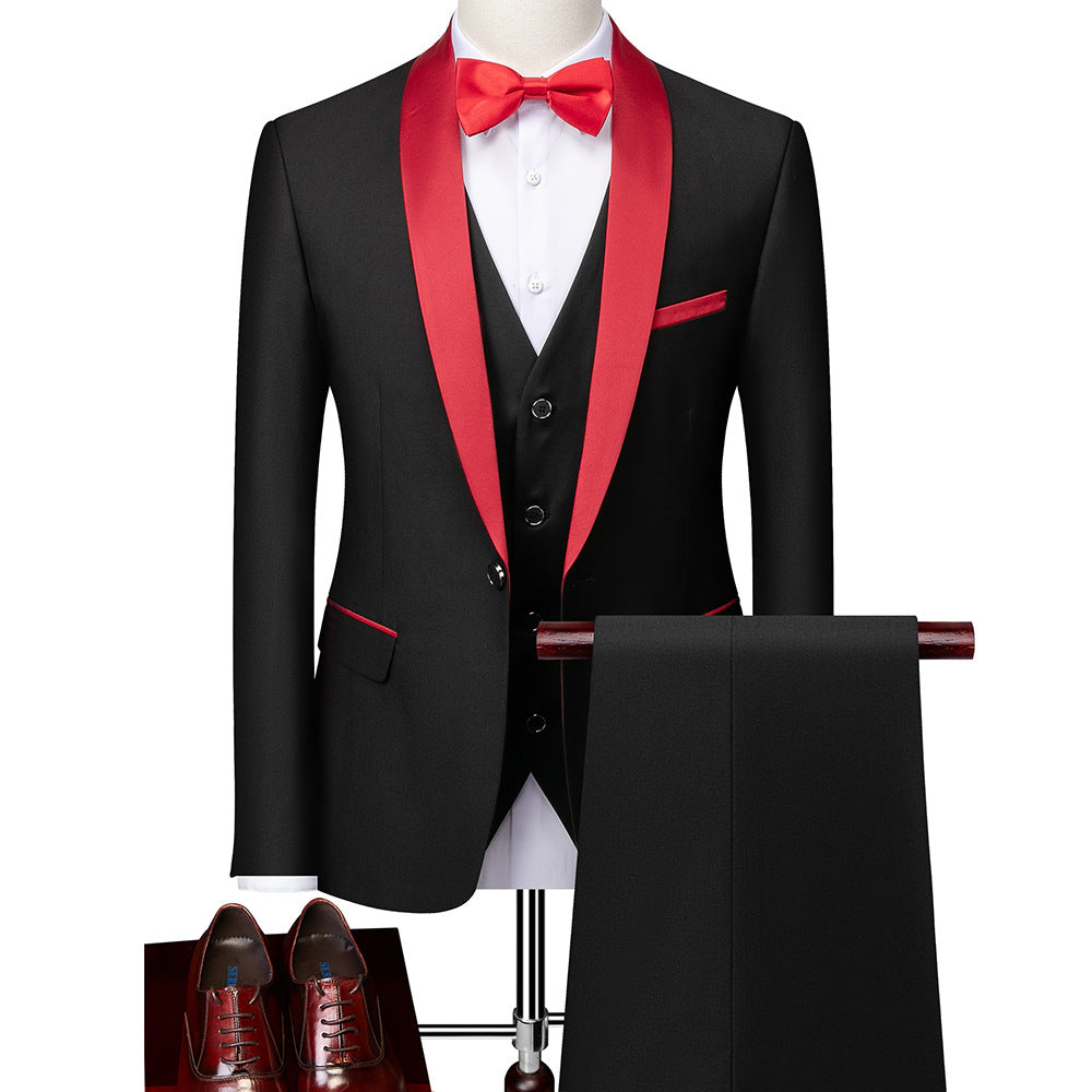 black tuxedo with red satin lapel, red bow tie, vest, black pants, and brown dress shoes on mannequin
