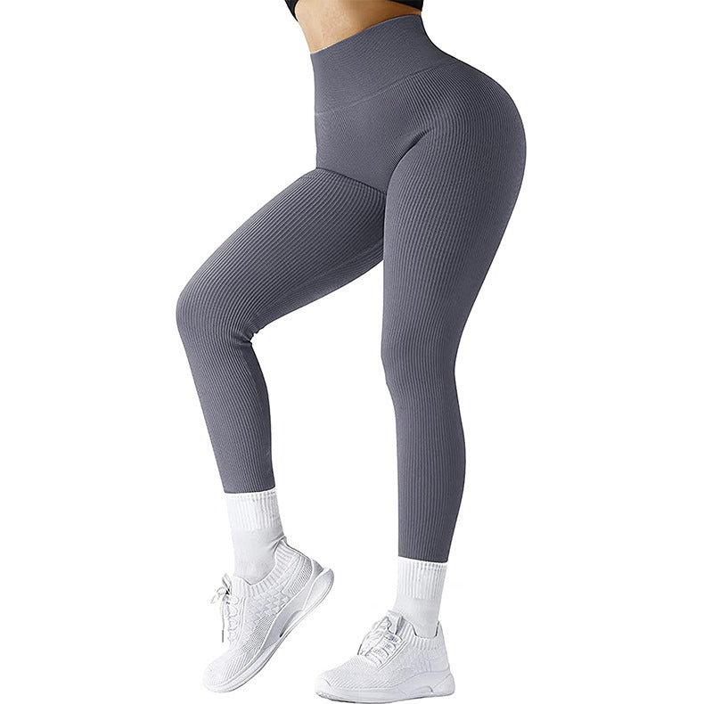 woman wearing high-waisted ribbed gray leggings with white socks and white athletic sneakers