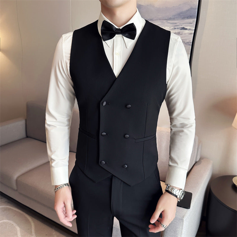 Man wearing black double-breasted vest with white dress shirt and black bow tie indoors