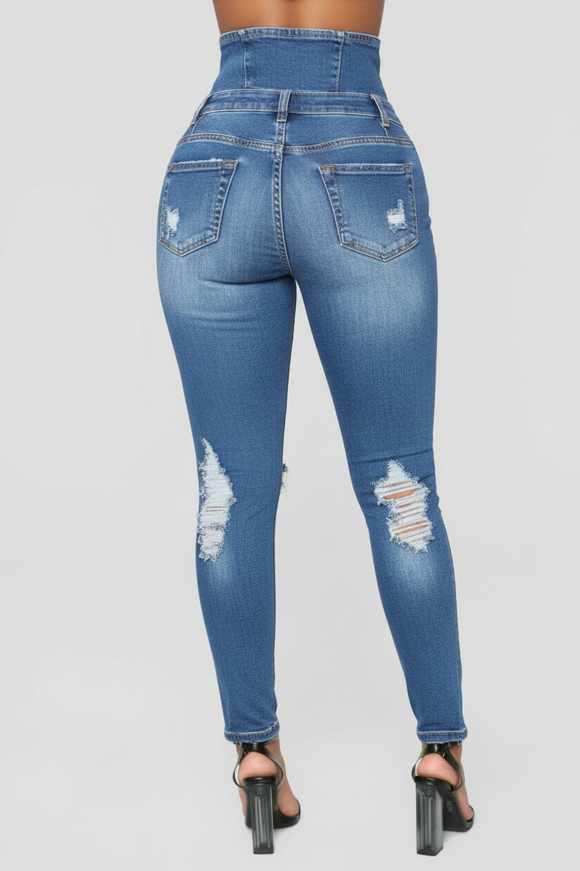 Back view of woman wearing high-waisted blue distressed skinny jeans with black block heels