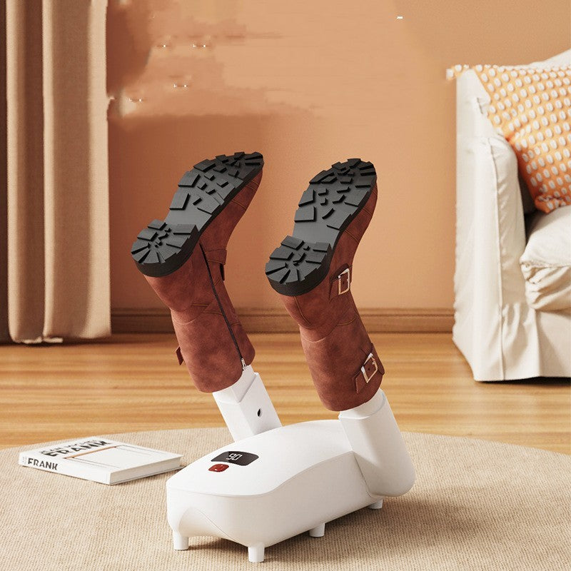 Modern white electric boot dryer with two brown boots on beige carpet in cozy living room