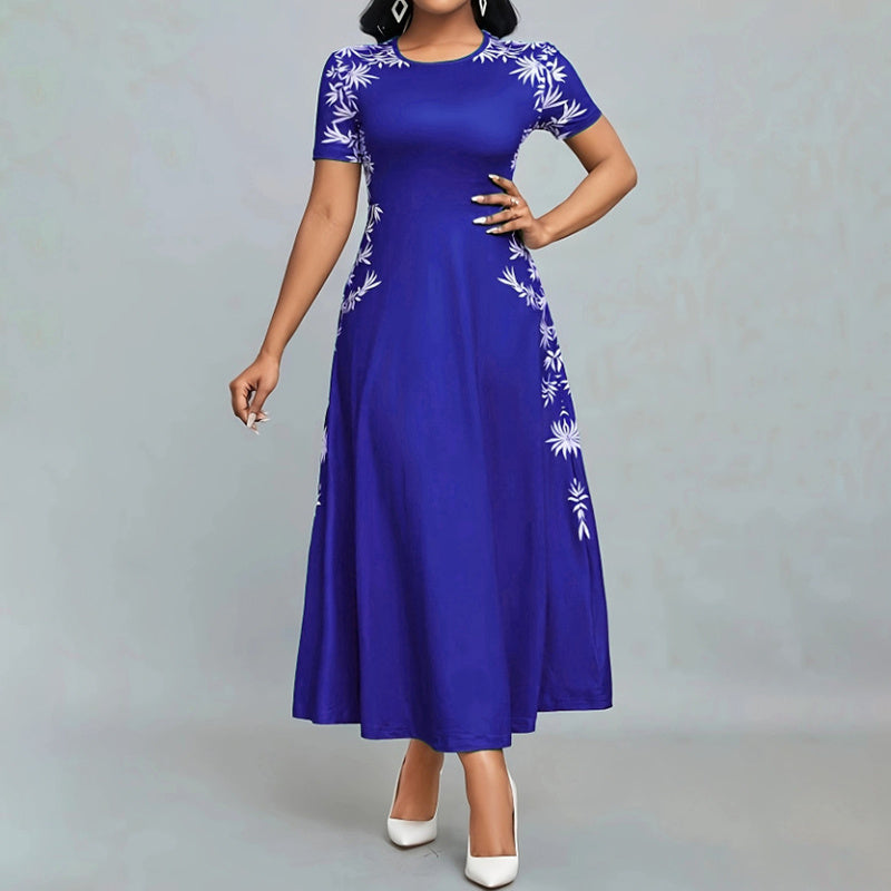 Woman wearing a royal blue maxi dress with white floral embroidery and white high heels