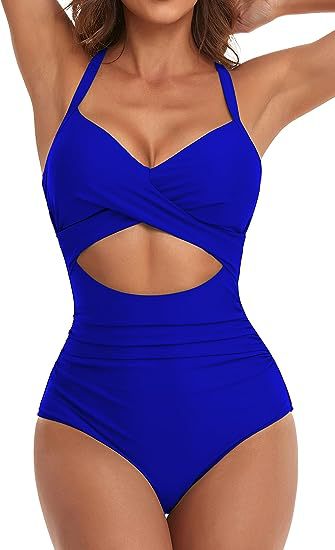 woman wearing royal blue one-piece swimsuit with halter straps and front cutout detail