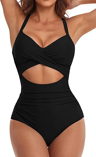 woman wearing black cutout one-piece swimsuit with twisted front design and halter straps