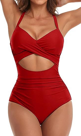 Woman wearing red cut-out one-piece swimsuit with halter straps and ruched waist detail
