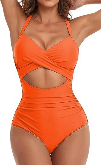 woman wearing an orange cut-out one-piece swimsuit with halter straps