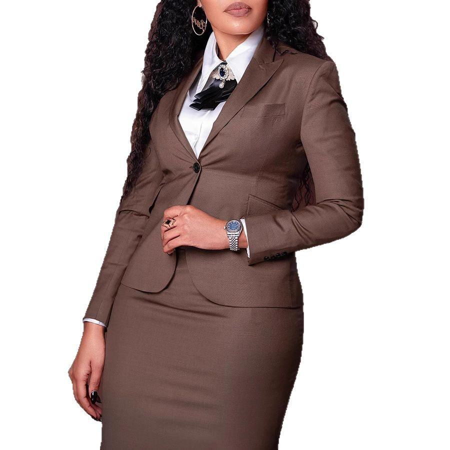Woman wearing brown business suit with white shirt and decorative brooch, silver watch