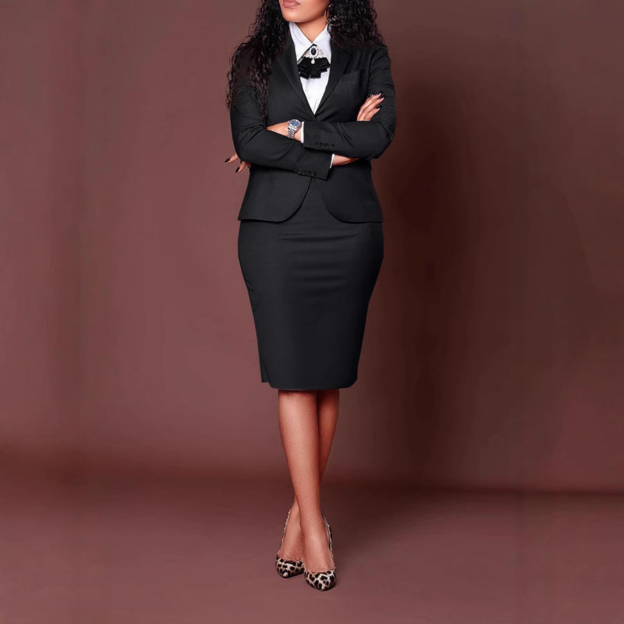 Woman in black business suit with white shirt and leopard print heels standing against brown background