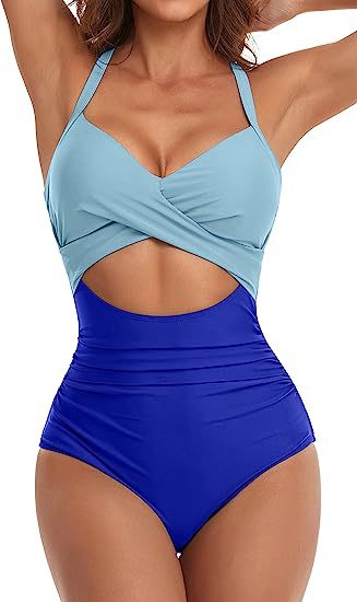 woman wearing color block cutout one-piece swimsuit with light blue top and royal blue high-waist bottom