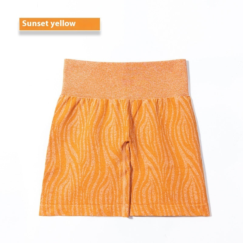Sunset yellow high-waisted shorts with textured wavy pattern on white background