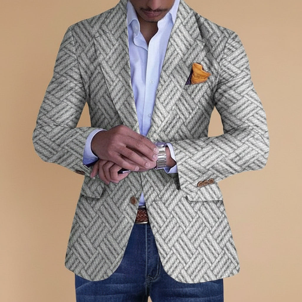 Man wearing grey patterned blazer with orange pocket square and checking silver wristwatch