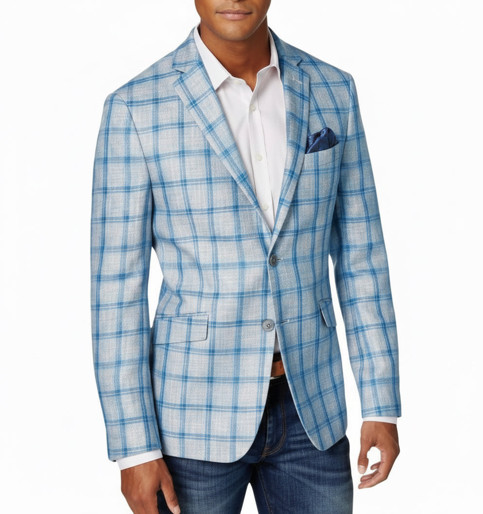Men's light blue plaid blazer with white shirt, navy pocket square, and jeans on model