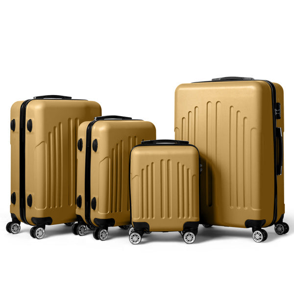Set of four gold hard-shell suitcases with black handles and wheels, varying sizes