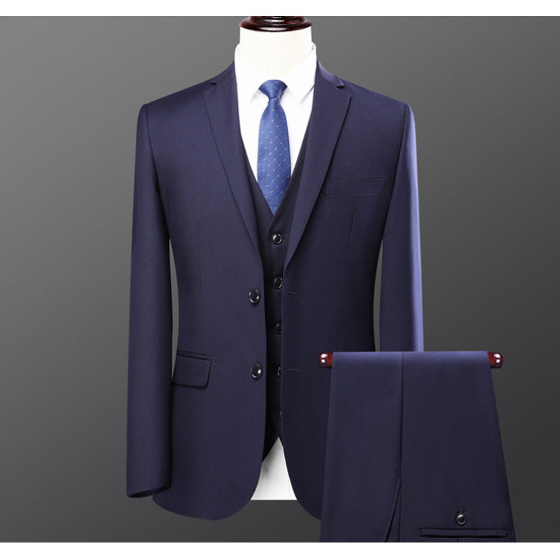 Navy blue three-piece men's suit with matching vest and blue patterned tie on mannequin