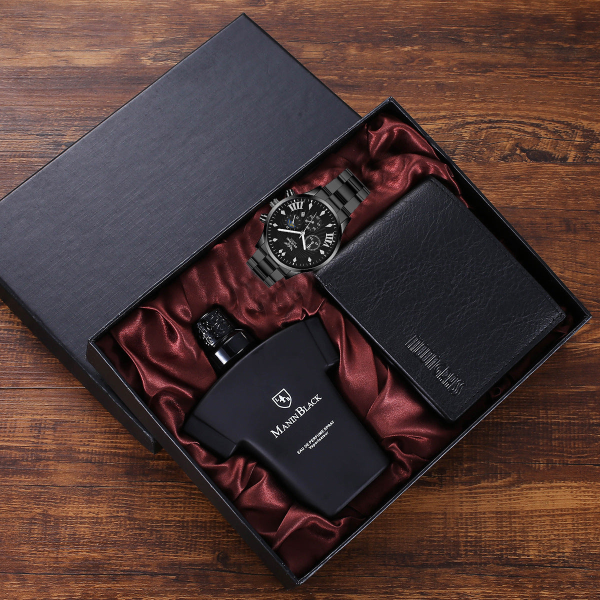 Luxury gift set with black men's wristwatch, Mannn Black perfume, and black wallet in satin-lined box