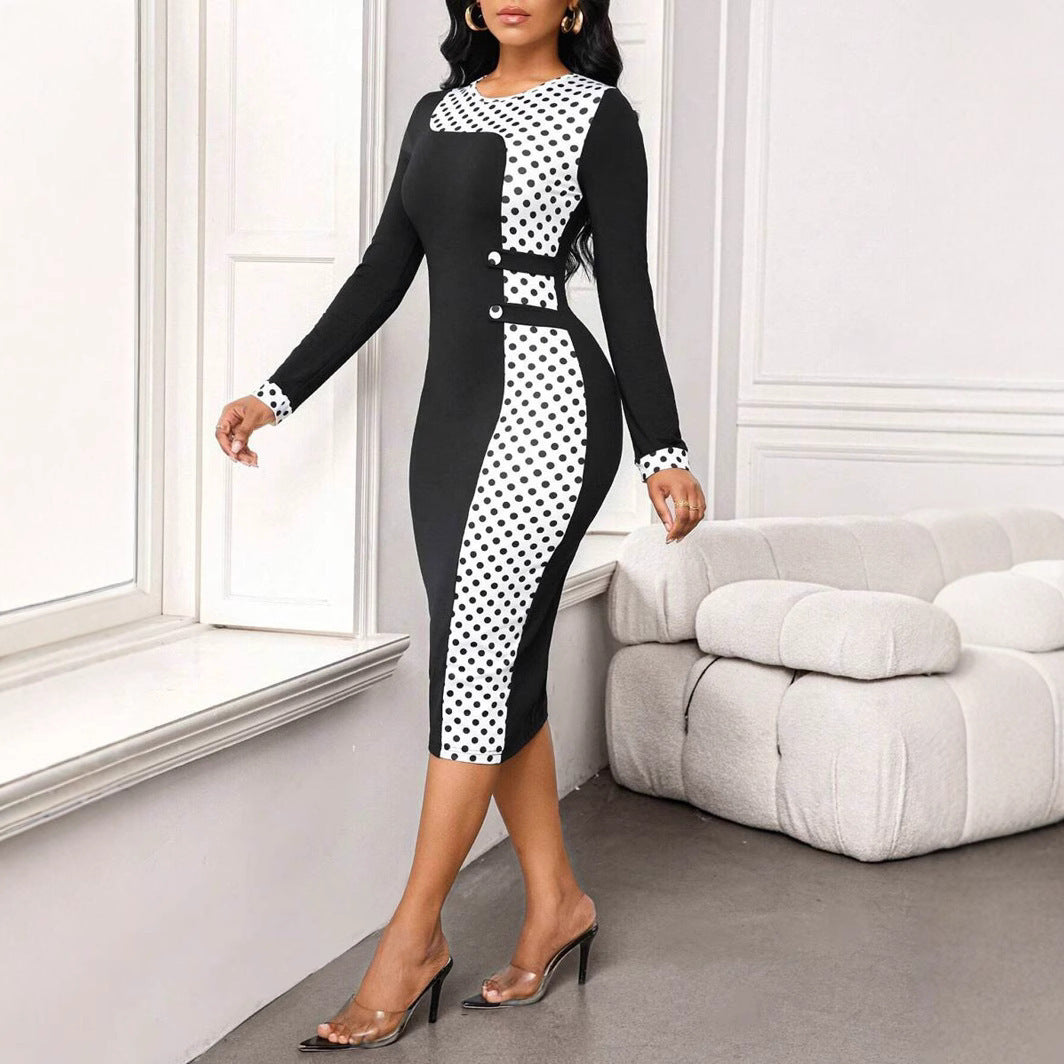 Woman in black and white polka dot midi dress with long sleeves, standing indoors by window