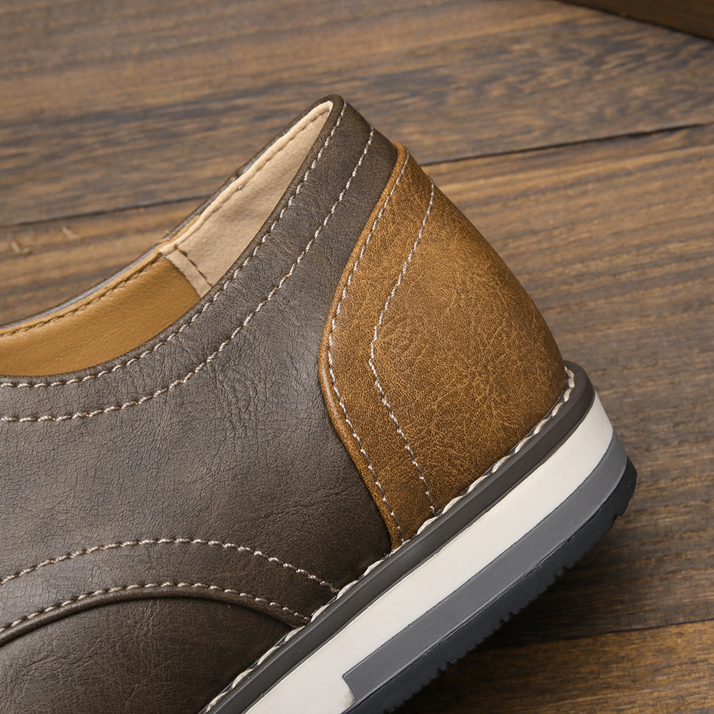 Close-up of brown leather casual shoe with white and gray sole on wooden floor