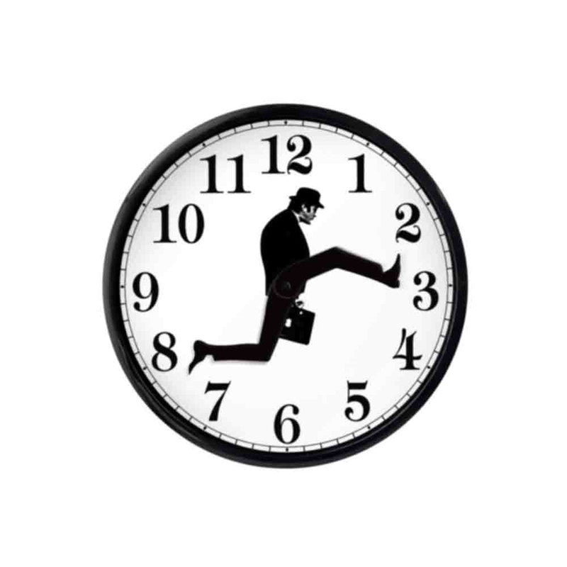 Round wall clock with black numbers and a silhouette of a man in a suit and hat doing a high leg kick