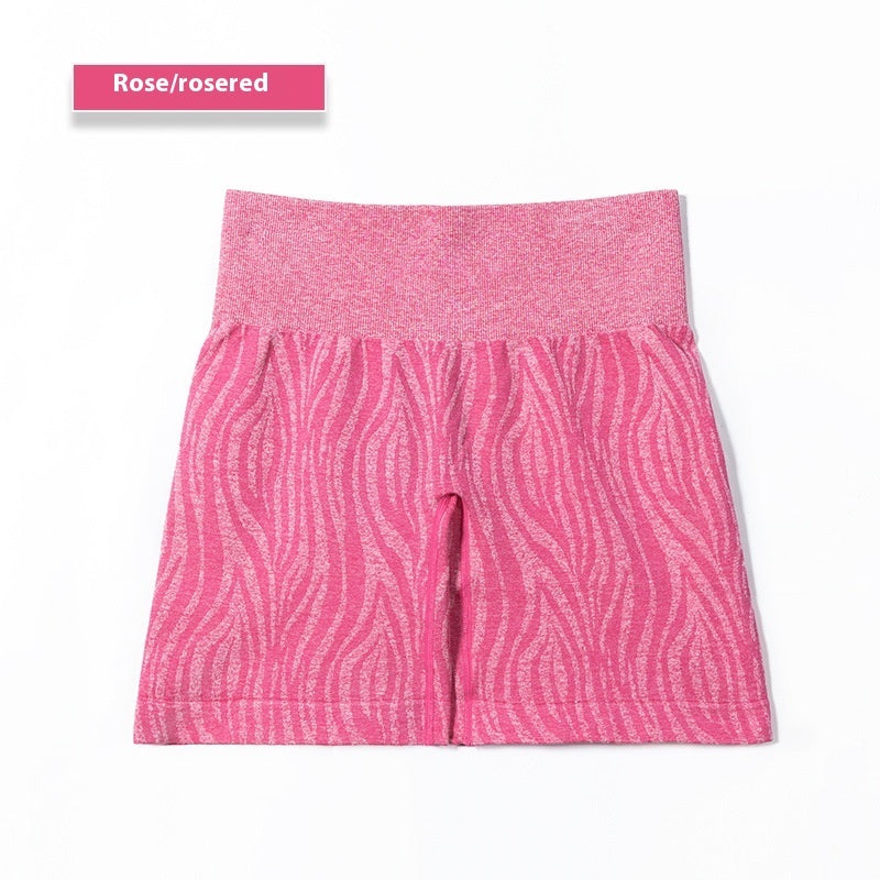 Rose-colored knit shorts with wavy striped pattern and wide waistband on white background