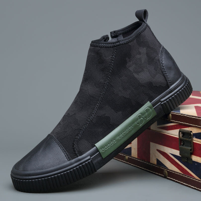 Black high-top sneaker with textured fabric and green side label on Union Jack vintage box