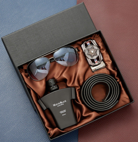 Luxury gift set with black sunglasses, designer watch, black leather belt, and Black Eau de Parfum in satin-lined box